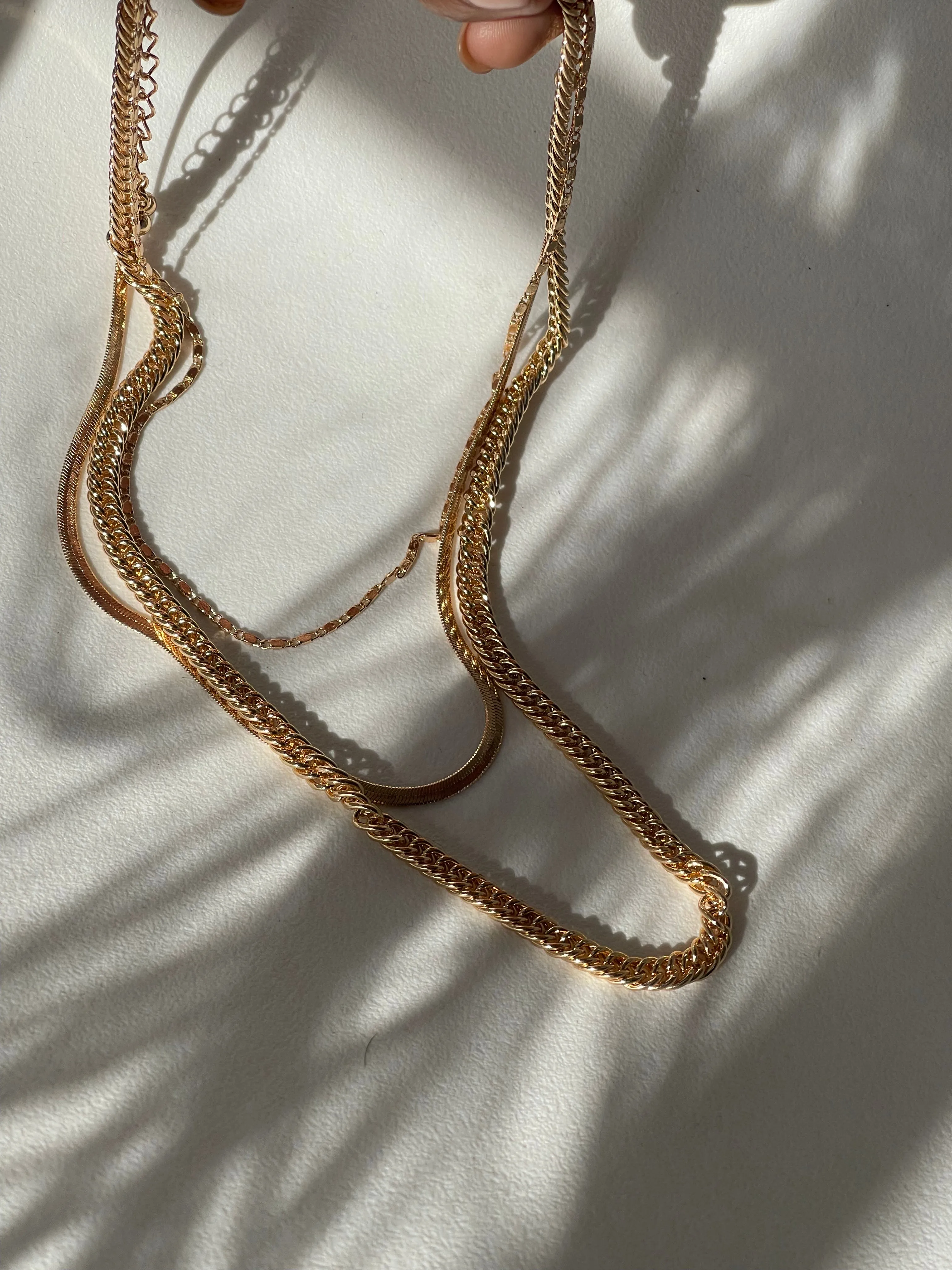 Liz Stainless Steel Tri Layered Necklace Set In Gold