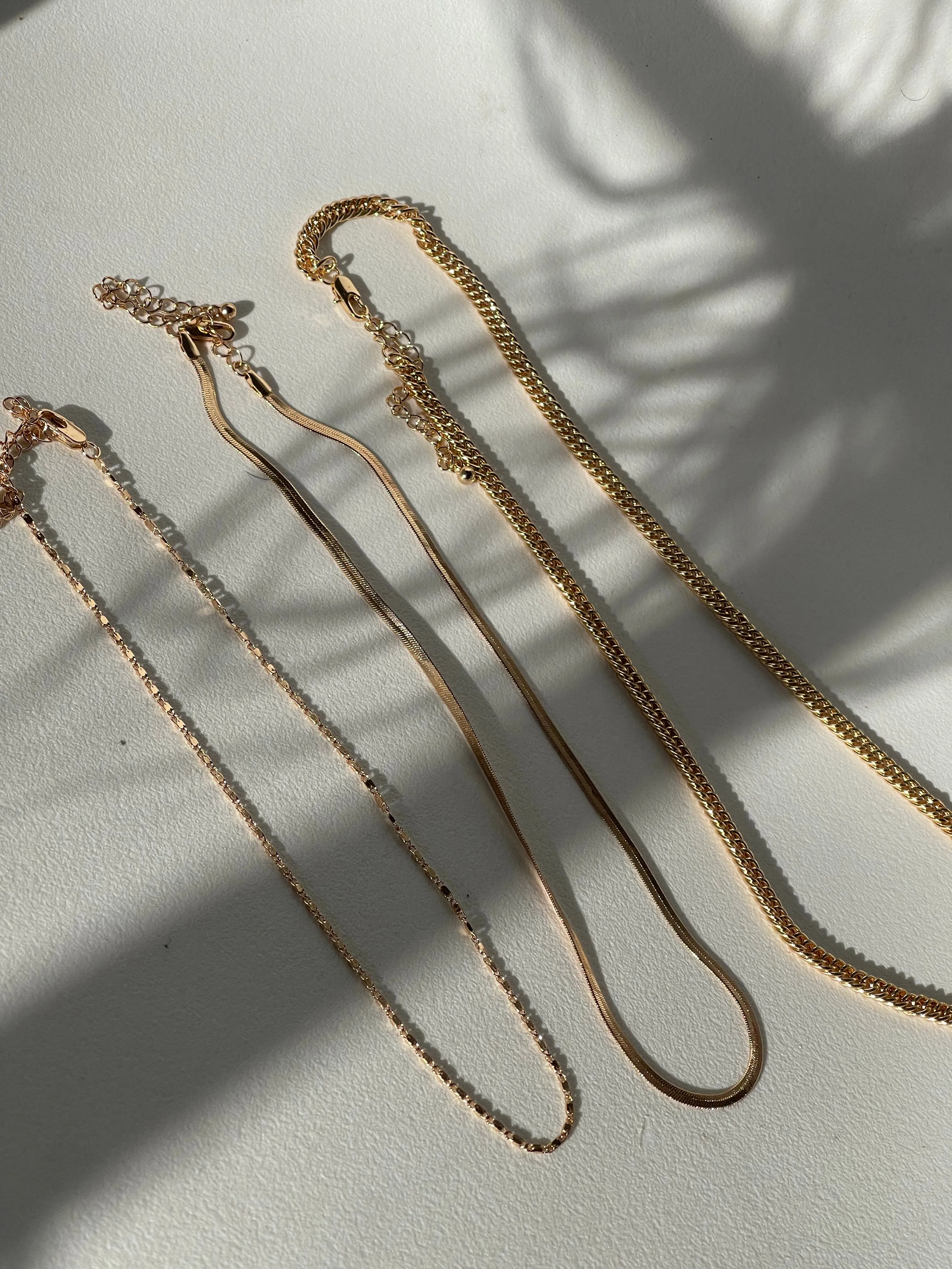 Liz Stainless Steel Tri Layered Necklace Set In Gold