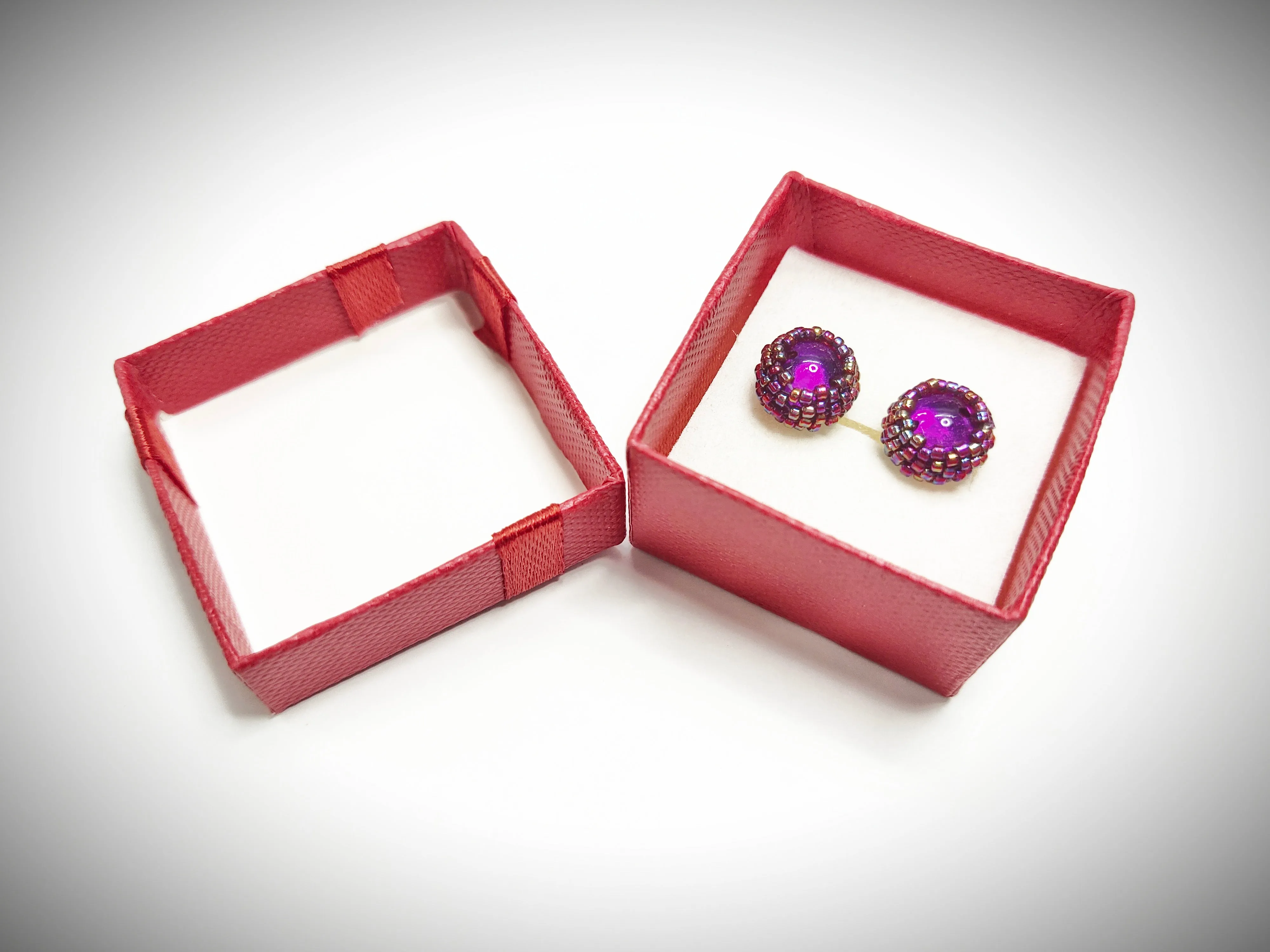 Shiny reddish purple beaded stud earrings