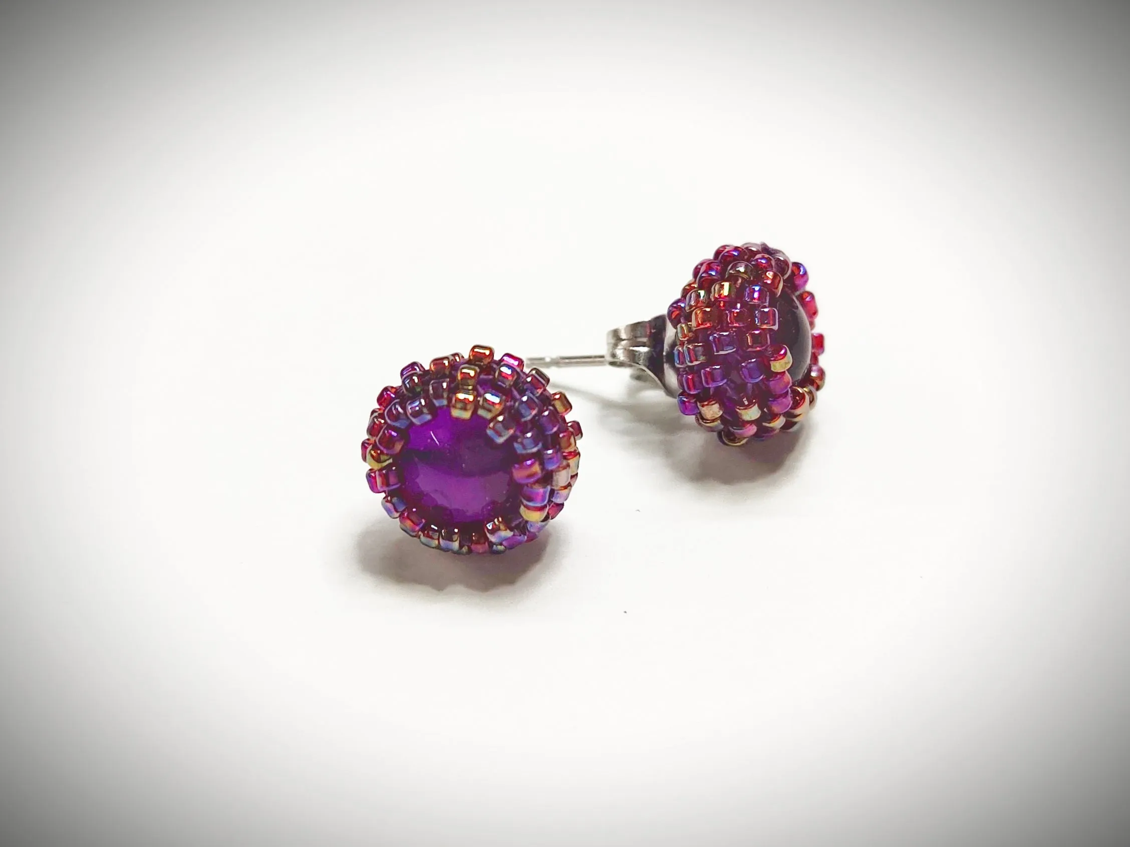 Shiny reddish purple beaded stud earrings